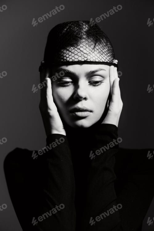 Preview: Elegant woman in black attire with a fishnet hat, expressing deep emotion and introspection against