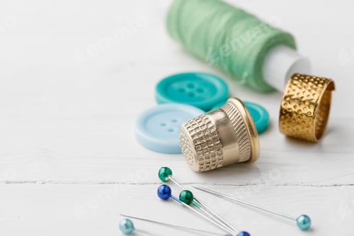 Preview: Colorful sewing accessories on white wooden table