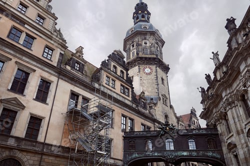 Preview: Low angle view of old dresden cathedral with clock, statues on building roof in Dresden, Germany