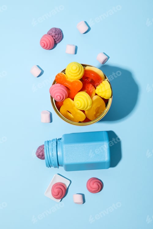 Preview: Jar and tin with jelly candies on blue background, top view