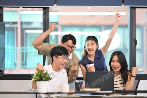 Preview: Excited business team celebrating victory or successful project results together in an office