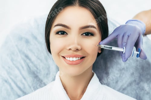 Preview: asian woman getting rejuvenation injection for fresh skin. Staying young and beautiful with