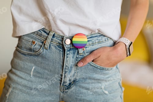 Preview: Part of body Stylish Woman in blue jeans with the LGBT pride flag sign.
