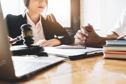 Preview: Business woman and lawyers discussing contract papers with brass scale on wooden desk in office. Law