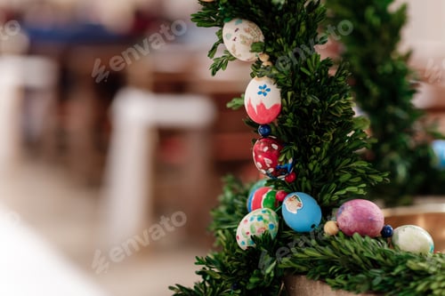 Preview: Green Christmas wreath with decorations on bright background.easter eggs