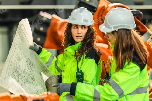 Preview: Engineer Reviewing Blueprint in Robotic Facility