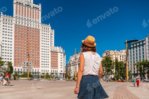 Preview: Young tourist woman in Spain square in the center of the capital of Madrid enjoying the holidays