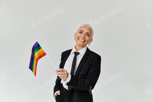 Preview: Stylish Mature Woman Celebrating Pride With a Rainbow Flag
