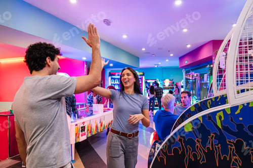 Preview: Friends giving high five, celebrating success playing in entertainment center