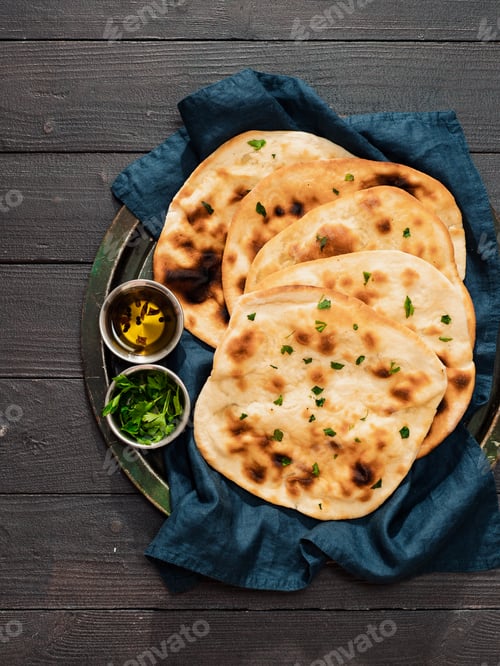 Preview: naan flatbreads on dark wood, copy space, vertical