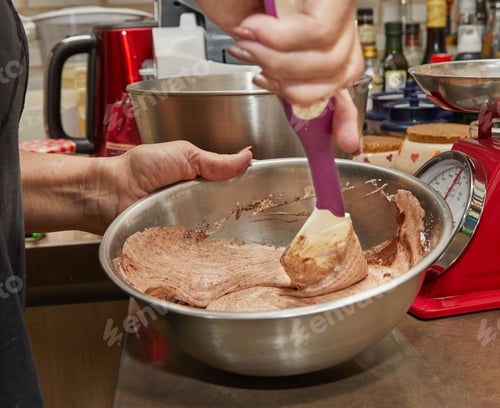 Preview: Chef mixes cocoa, flour with the rest of the ingredients in bowl for making pie