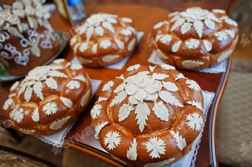 Preview: Close-up photo of tasty baked and decorated wedding bread.