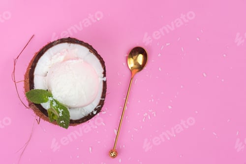 Preview: Vanilla ice cream balls in a fresh coconut half decorated with mint leaves with a spoon on a pink