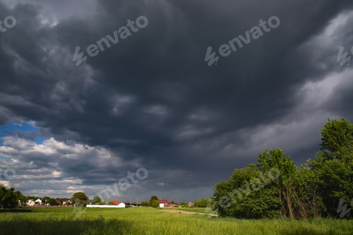 Preview: Panorama of rural landscape at wild changing stormy weather condition with rain and sun
