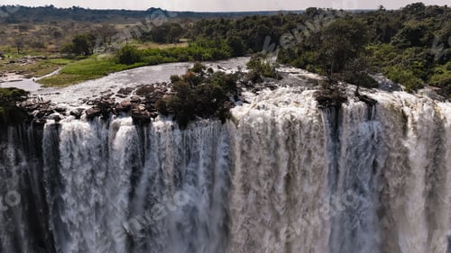 Preview: Kalandula Waterfall cascades beautifully in Angola, surrounded by lush greenery during daylight