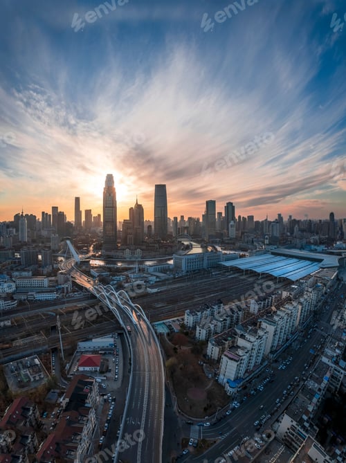 Preview: Aerial shot of an urban skyline with landmarks along the Haihe River in Tianjin, China at sunset