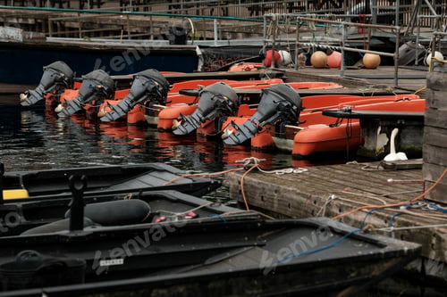 Preview: Rowboats with outboard motors moored at marina dock