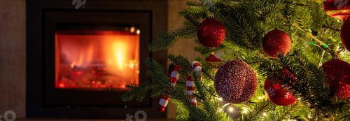Preview: Christmas tree decoration and lights close up view, burning fireplace background.