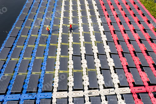 Preview: Wide shot of aeroview or top view of two technician workers walk along the solar panel system