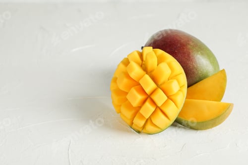 Preview: Cut ripe mangoes and space for text on white background, closeup