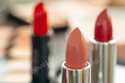 Preview: Pink and red lipsticks on vanity table