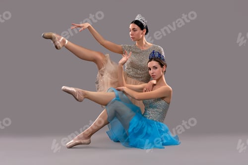 Preview: Two beautiful ballerinas sitting in studio and posing