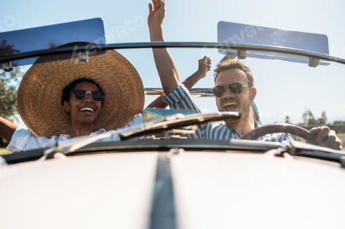Preview: Multiracial couple in a convertible vintage car