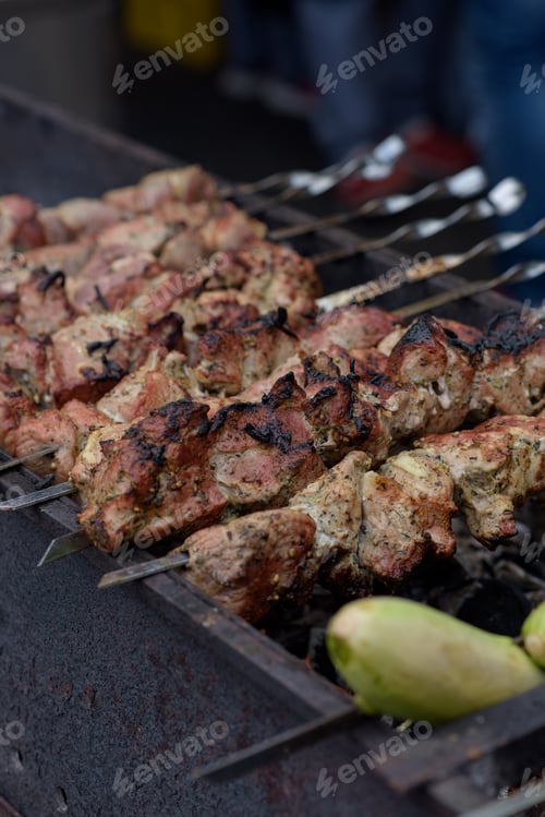 Preview: Grilled skewers of meat on the coals, with smoke. street food.