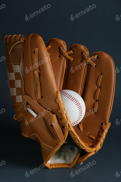 Preview: Catcher's mitt and baseball ball on dark background. Sports game