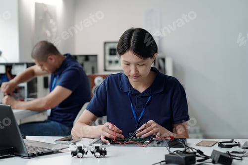 Preview: Focused Engineer Soldering Circuit Board in Lab Setting