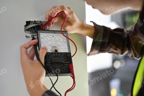 Preview: Electrician using a multimeter to test the electrical installation and power line current.