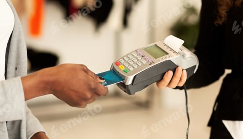 Preview: Customer Paying With Credit Card In Fashion Showroom, Closeup, Cropped
