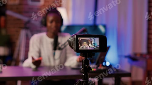 Preview: Selective focus on african american woman influencer talking in front of digital camera recording