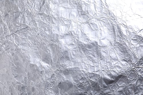 Preview: Crumpled silver foil as background, closeup view