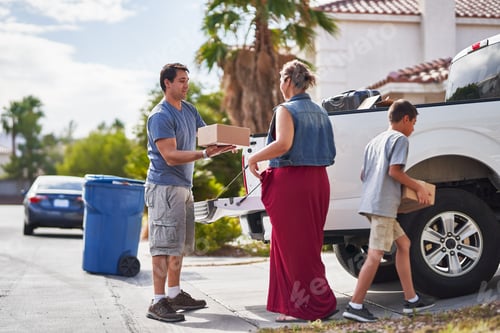 Preview: hispanic family moving boxes out of pickup truck into house