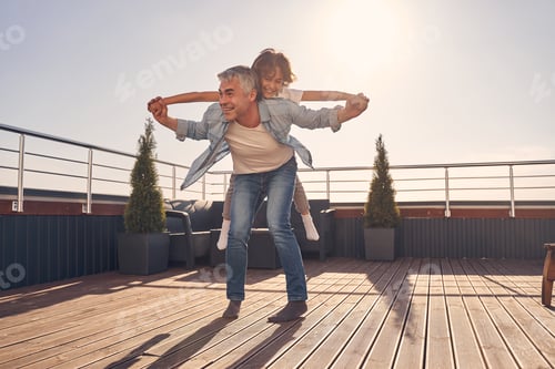 Preview: Two Caucasian people playing on the roof of the house