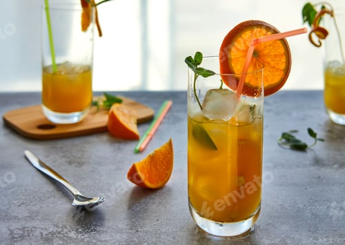 Preview: Photo of fresh orange juice in the glass jar. Summer healthy organic drink concept.