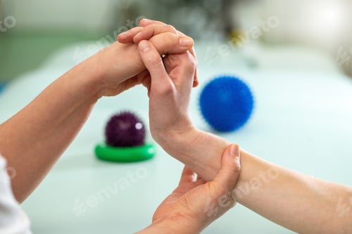Preview: Doctor exercising and making rehabilitation with patient wrist