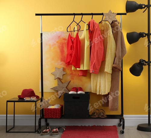 Preview: Stylish dressing room interior with clothes on rack