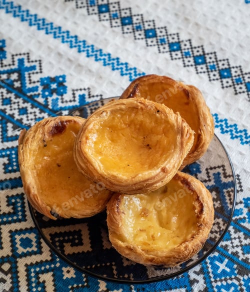 Preview: Closeup shot of Portuguese egg custard tarts on a plate