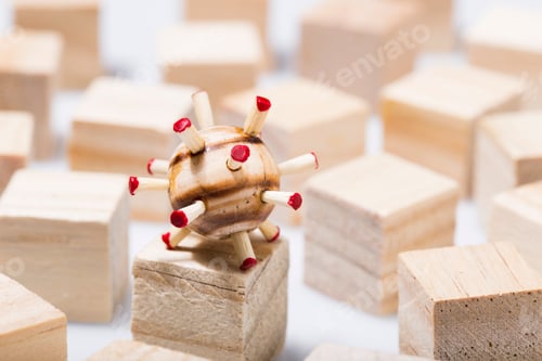 Preview: Small piece of wood representing the covid-19 virus, on wooden cubes
