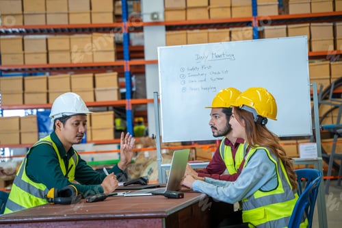 Preview: Group of warehouse workers have a briefing in a large distribution center.