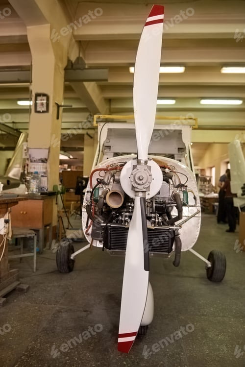 Preview: Light airplane in workshop.