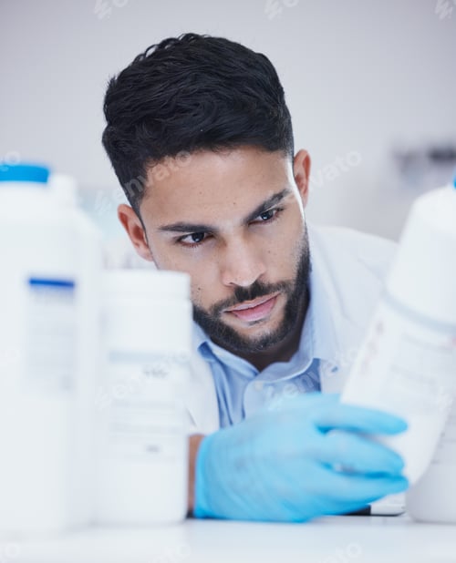 Preview: Laboratory, man or scientist reading bottle at pharmaceutical laboratory checking stock or info on
