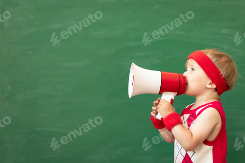 Preview: Happy child student speaking by megaphone in class