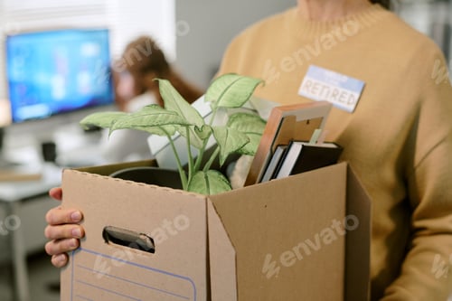 Preview: Middle Aged Woman Holding Box with Office Supplies after Retiring