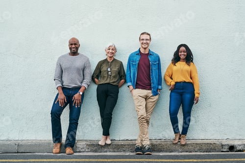 Preview: Full length shot of a group of businesspeople standing in line against a wall outdoors