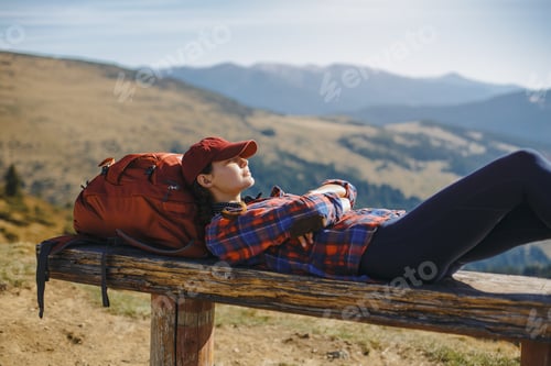 Preview: Female Hiker Resting on Top of the Mountain