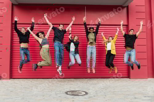 Preview: Group of cheerful diverse friends celebrating and jumping in air