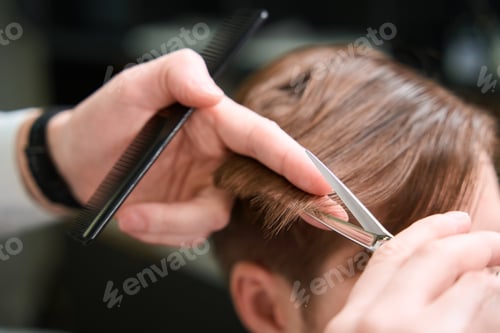 Preview: Photo of barber using scissors and comb indoors